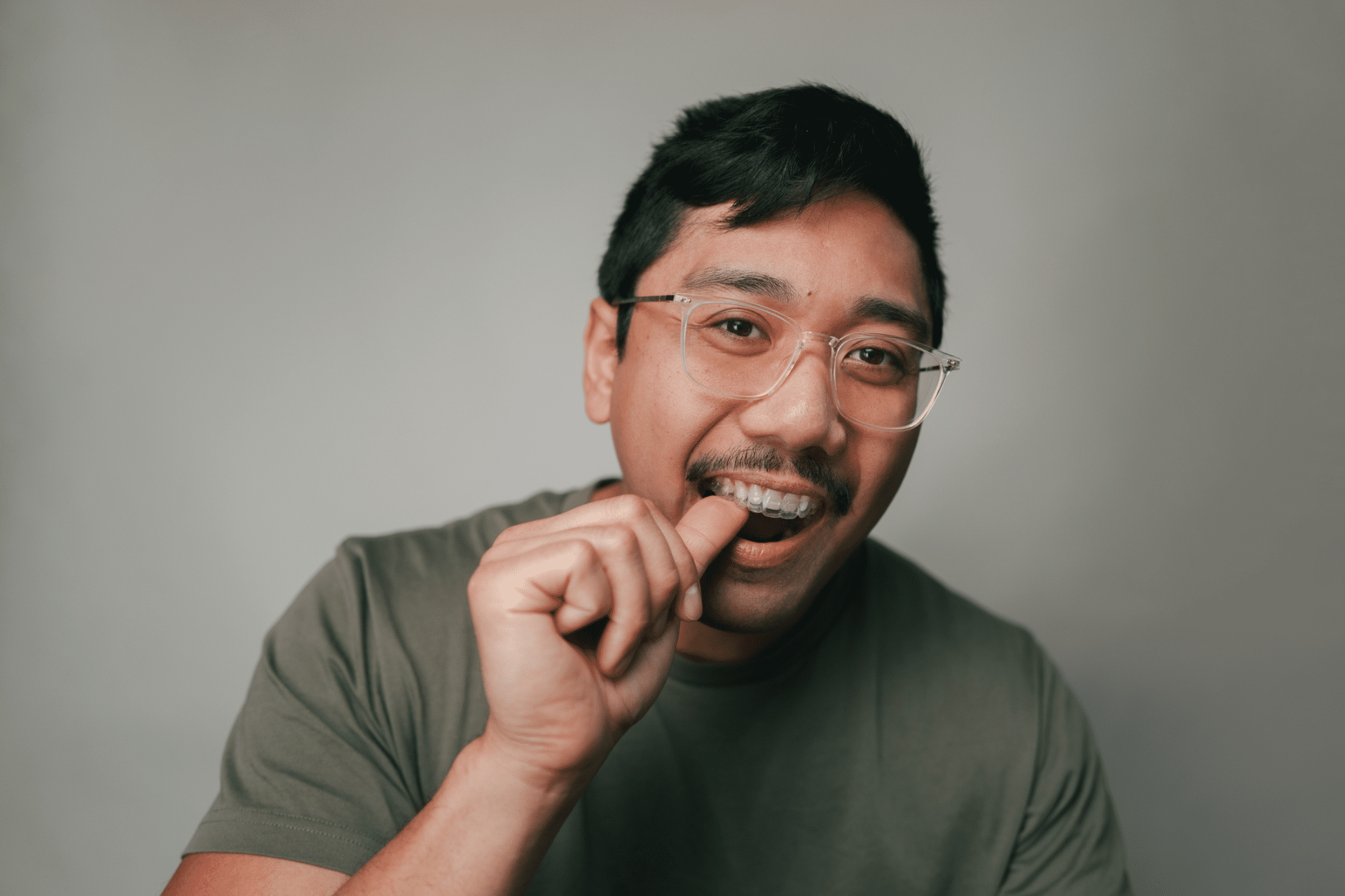 Adult wearing clear aligners for shifting teeth in Ann Arbor, MI